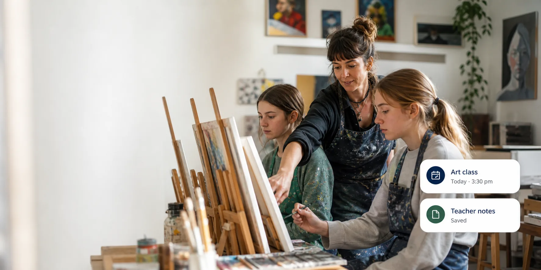 An art educator guiding students working at easels